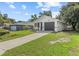 Single story home with a driveway and a well-maintained lawn on a bright day at 9413 5Th Ave, Orlando, FL 32824