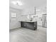 Modern kitchen with a large island, white cabinets, and stainless steel appliances at 9413 5Th Ave, Orlando, FL 32824