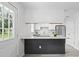 Well-lit kitchen with an island that has barstool seating and stainless steel appliances at 9413 5Th Ave, Orlando, FL 32824