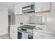 Bright kitchen featuring stainless steel appliances, quartz countertops, and open concept living space at 9413 5Th Ave, Orlando, FL 32824