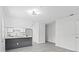Open concept view of kitchen, living room, and doorway with sleek gray flooring at 9413 5Th Ave, Orlando, FL 32824