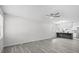 Open living room showcasing gray floors and a breakfast bar overlooking modern kitchen at 9413 5Th Ave, Orlando, FL 32824