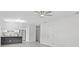 View of the living room opening up to the adjacent kitchen with stainless steel appliances at 9413 5Th Ave, Orlando, FL 32824