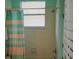 Compact bathroom featuring a shower with neutral colored shower curtain at 189 Minniehaha Cir, Haines City, FL 33844