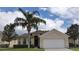 Charming single-Gathering home with a well-manicured lawn, mature trees, and a two-car garage at 189 Minniehaha Cir, Haines City, FL 33844