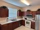 Well-lit kitchen with stainless steel appliances, ample cabinet space, and white countertops at 189 Minniehaha Cir, Haines City, FL 33844