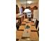 Inviting kitchen and dining area with a table set for a meal, featuring warm lighting and decor at 189 Minniehaha Cir, Haines City, FL 33844