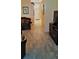 Open-concept living room and hallway with wood-look floors and front door at 189 Minniehaha Cir, Haines City, FL 33844