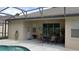 Pool patio with a dining area, featuring a covered lanai perfect for outdoor dining and entertaining at 189 Minniehaha Cir, Haines City, FL 33844