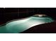 Beautifully lit backyard pool at night, creating a serene and inviting ambiance at 189 Minniehaha Cir, Haines City, FL 33844
