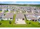 Drone eye-view showcasing the property with a paved patio in the backyard at 2296 Crossbow St, Clermont, FL 34715