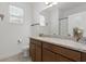Bathroom with granite vanity top, under-mount sink, and framed mirror at 2296 Crossbow St, Clermont, FL 34715
