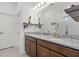 Bathroom with double granite vanity, dual sinks, and a separate shower at 2296 Crossbow St, Clermont, FL 34715