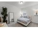 Bright bedroom with floral pattern linens and full length mirror at 2296 Crossbow St, Clermont, FL 34715
