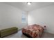 Bedroom with gray carpet, window with blinds, and side table at 2296 Crossbow St, Clermont, FL 34715