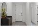 Bright entryway with a modern cabinet, round mirror, and decorative flowers at 2296 Crossbow St, Clermont, FL 34715