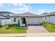 Charming single-story home featuring a two-car garage and a well-manicured lawn at 2296 Crossbow St, Clermont, FL 34715