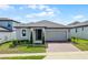 Charming single-story home featuring a two-car garage and a well-manicured lawn at 2296 Crossbow St, Clermont, FL 34715