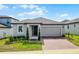 Charming single-story home featuring a two-car garage and a well-manicured lawn at 2296 Crossbow St, Clermont, FL 34715