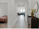Long hallway with tile flooring and a view of the living room at 2296 Crossbow St, Clermont, FL 34715