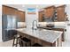 Modern kitchen featuring an island, granite countertops, and stainless steel appliances at 2296 Crossbow St, Clermont, FL 34715