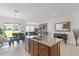 Open concept kitchen with granite island, stainless appliances, and adjacent dining area at 2296 Crossbow St, Clermont, FL 34715