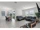 Open-concept living room with tile floors and access to the dining area at 2296 Crossbow St, Clermont, FL 34715