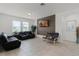 Spacious living room with tile floors, two windows, and comfortable seating at 2296 Crossbow St, Clermont, FL 34715