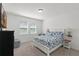 Spacious main bedroom with natural light and a cozy armchair at 2296 Crossbow St, Clermont, FL 34715
