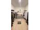 Spacious walk-in closet with ample hanging and storage space, and a bench in the middle at 2296 Crossbow St, Clermont, FL 34715