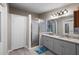 Modern bathroom featuring a double sink granite vanity and a standup glass shower with a shower seat at 2912 Fletcher Ave, Lakeland, FL 33803