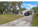Property with driveway, palm trees, shed, and mobile home at 2912 Fletcher Ave, Lakeland, FL 33803