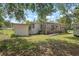 Charming single-story home with a spacious wooden deck, mature trees, and plenty of outdoor space at 2912 Fletcher Ave, Lakeland, FL 33803