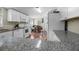 Bright kitchen featuring granite countertops, white cabinets, stainless steel appliances and an open dining area at 2912 Fletcher Ave, Lakeland, FL 33803