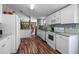 Bright kitchen with modern appliances, granite countertops, and ample storage space, with wood flooring and white cabinets at 2912 Fletcher Ave, Lakeland, FL 33803