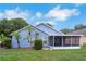 Blue home with small palm trees in a backyard at 4217 Kingbird Ct, Orlando, FL 32826