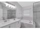 Bathroom with double vanity, soaking tub, and glass-enclosed shower at 4217 Kingbird Ct, Orlando, FL 32826
