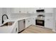 Stylish kitchen with white cabinets, stainless steel appliances, and quartz countertops at 4217 Kingbird Ct, Orlando, FL 32826