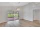 Spacious living area with wood floors and sliding doors leading to a screened lanai at 4217 Kingbird Ct, Orlando, FL 32826