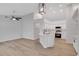 Open-concept living space with modern kitchen, wood floors, and vaulted ceilings at 4217 Kingbird Ct, Orlando, FL 32826