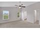 Spacious main bedroom featuring plush carpet, vaulted ceilings, and two bright windows at 4217 Kingbird Ct, Orlando, FL 32826