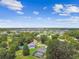 Aerial view of a neighborhood with lush trees, lakes, and a house with a screened pool at 4221 Meadowbend Ct, Lakeland, FL 33811