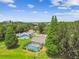 Aerial view of a single Gathering home with a large, screened-in pool and lush greenery at 4221 Meadowbend Ct, Lakeland, FL 33811