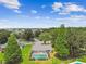 Aerial view of a house with a screened pool in a verdant, tree-lined neighborhood at 4221 Meadowbend Ct, Lakeland, FL 33811