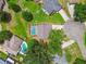 Aerial view of a home featuring a private backyard pool and mature trees at 4221 Meadowbend Ct, Lakeland, FL 33811