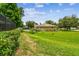 The property features a spacious green lawn and landscaping, perfect for outdoor activities at 4221 Meadowbend Ct, Lakeland, FL 33811