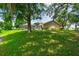 The house sits on a green lawn, offering a tranquil retreat for relaxation and recreation at 4221 Meadowbend Ct, Lakeland, FL 33811