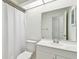 This bathroom features a shower with curtain, toilet, and large vanity mirror at 4221 Meadowbend Ct, Lakeland, FL 33811