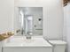 Bathroom with vanity, toilet, and a mirrored view of a nearby window at 4221 Meadowbend Ct, Lakeland, FL 33811