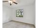 This bedroom features neutral carpet, a ceiling fan, and a window with backyard view at 4221 Meadowbend Ct, Lakeland, FL 33811